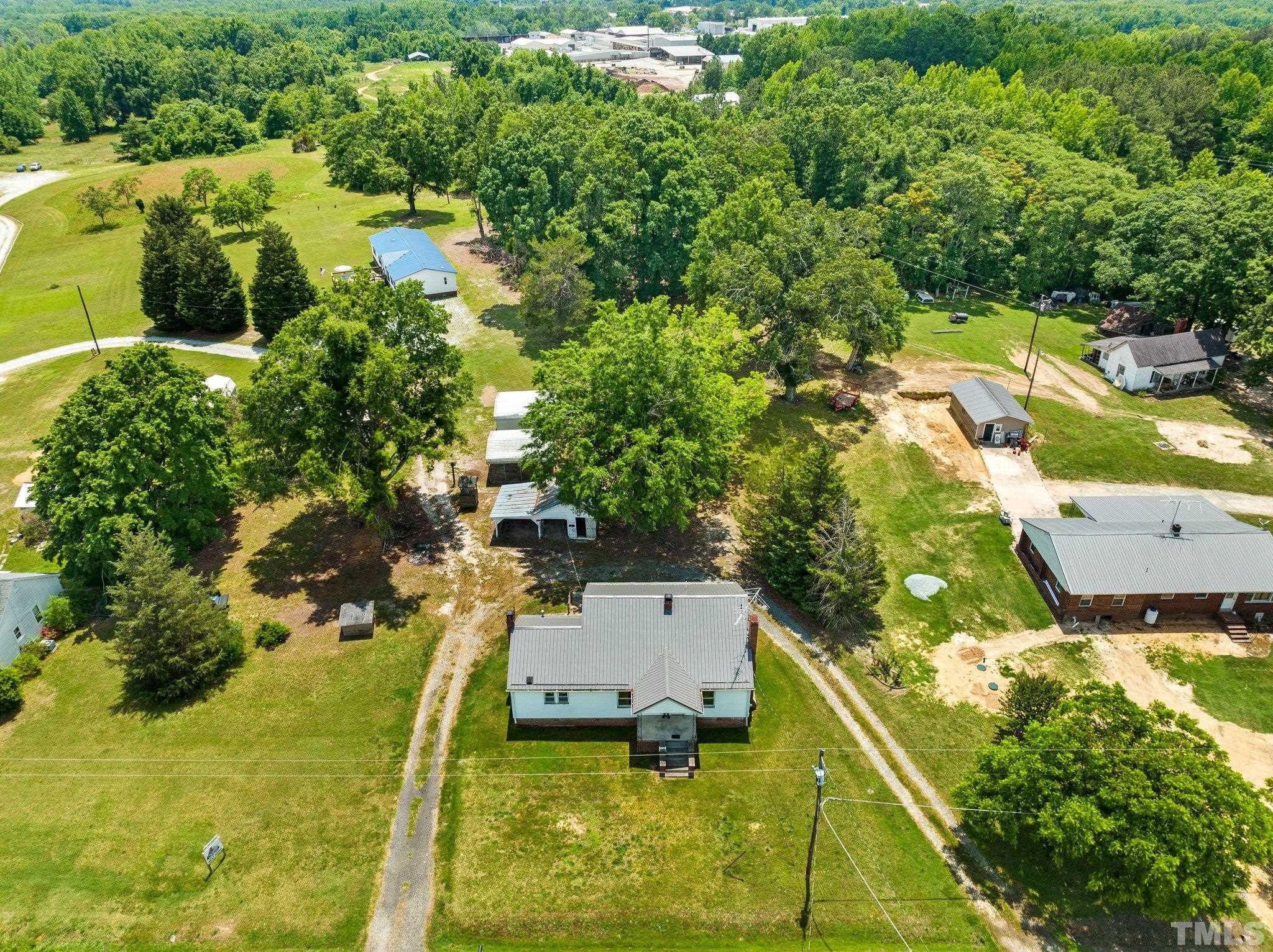 218 Oxford Road Roxboro, NC 27573 - Photo 2 of 16 an aerial view of residential houses with outdoor space