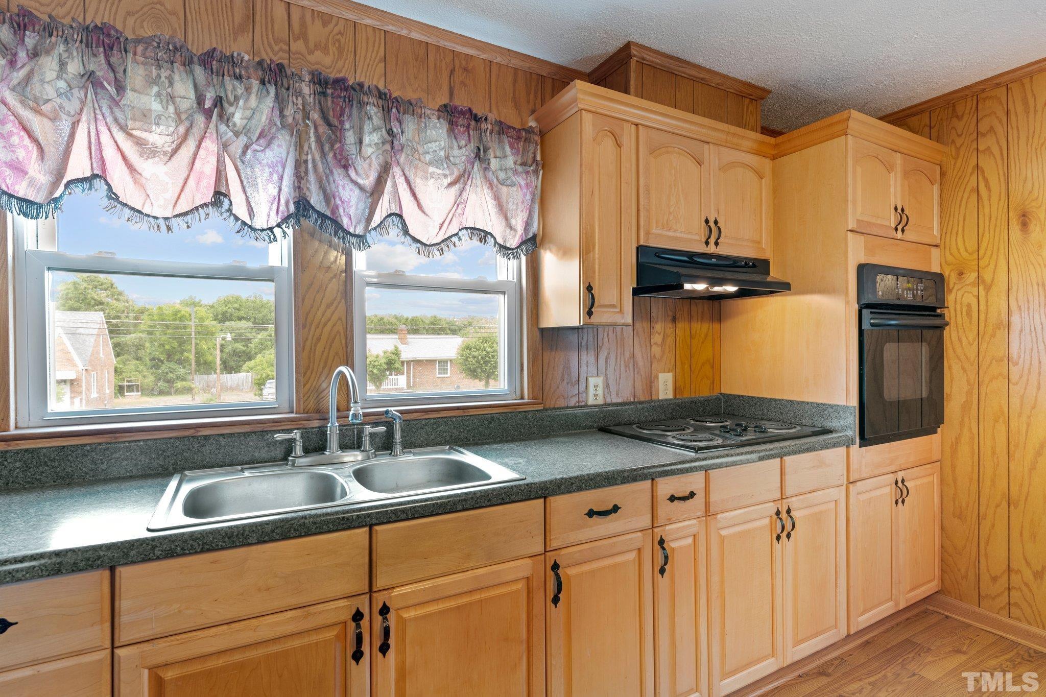 218 Oxford Road Roxboro, NC 27573 - Photo 3 of 16 a kitchen with stainless steel appliances granite countertop a sink and a granite counter tops with a window