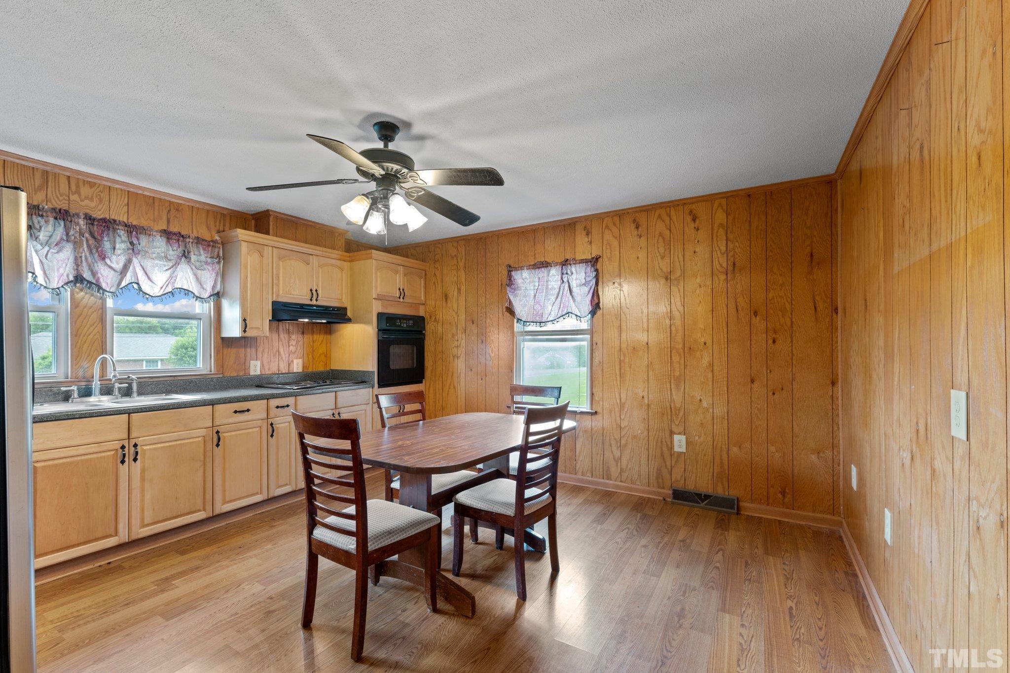 218 Oxford Road Roxboro, NC 27573 - Photo 6 of 16 a dining room with stainless steel appliances granite countertop furniture a chandelier and wooden floor