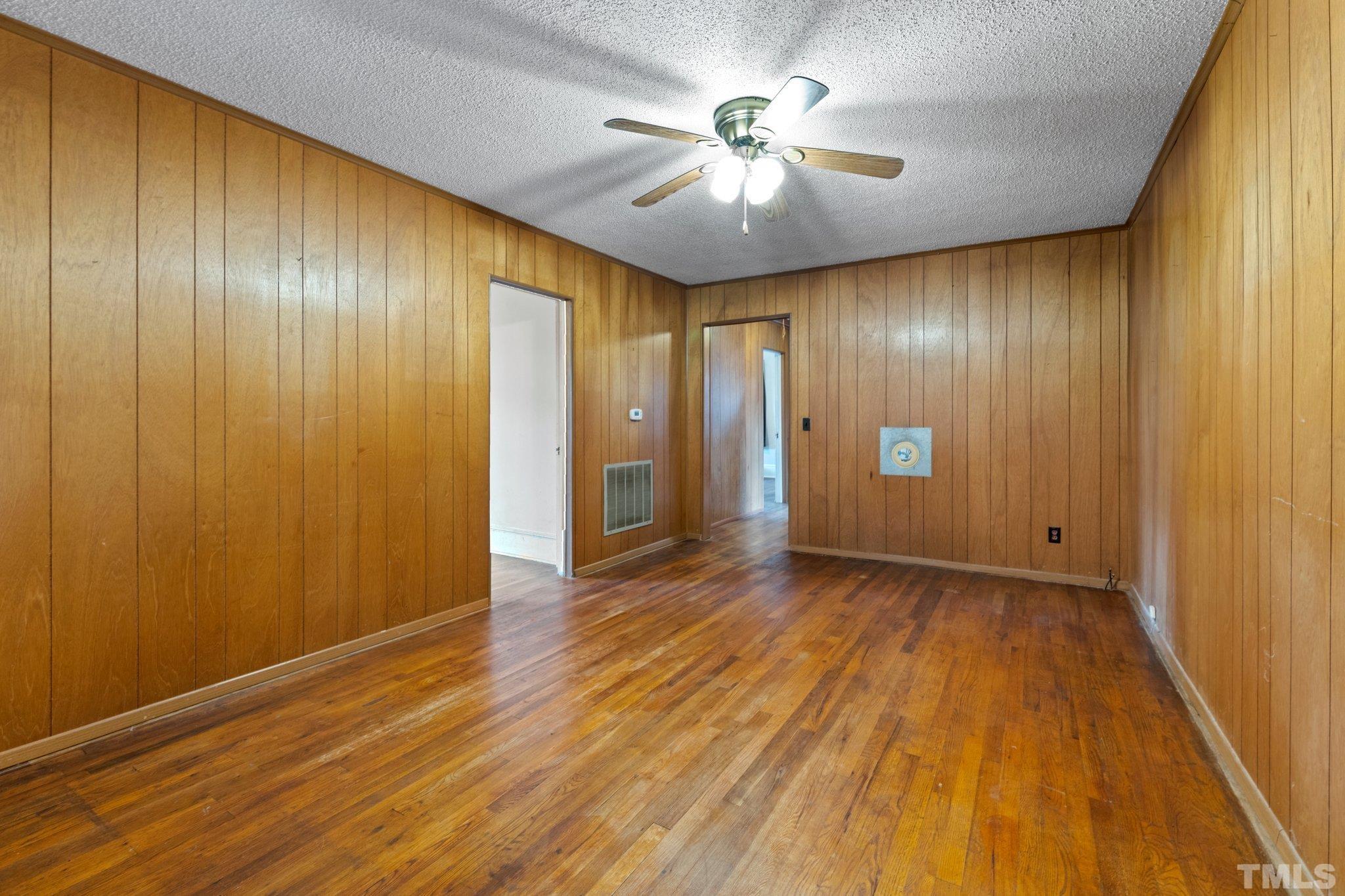 218 Oxford Road Roxboro, NC 27573 - Photo 10 of 16 a view of an empty room with wooden floor