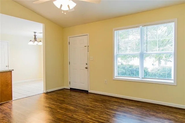 a view of kitchen with stainless steel appliances granite countertop a refrigerator and a stove top oven