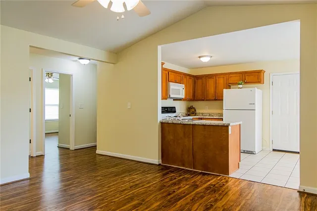 a kitchen with stainless steel appliances granite countertop a refrigerator sink and cabinets