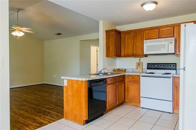 a kitchen with stainless steel appliances granite countertop a sink stove and cabinets