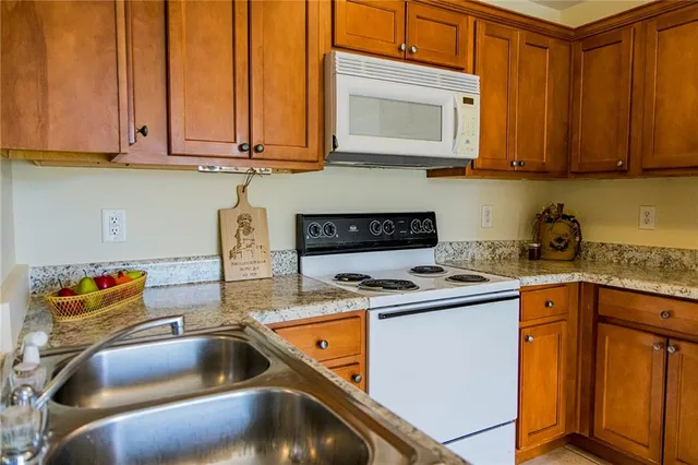 a kitchen with a stove a sink and a refrigerator