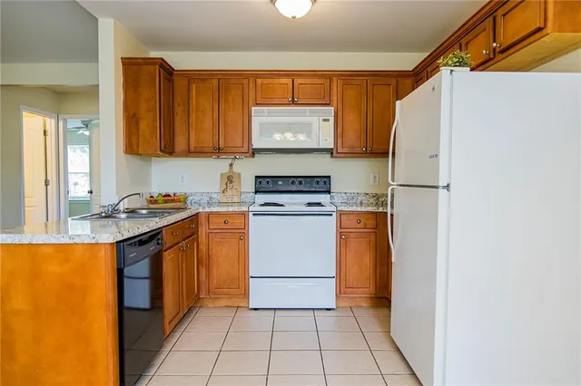 a utility room with granite countertop cabinets washer and dryer