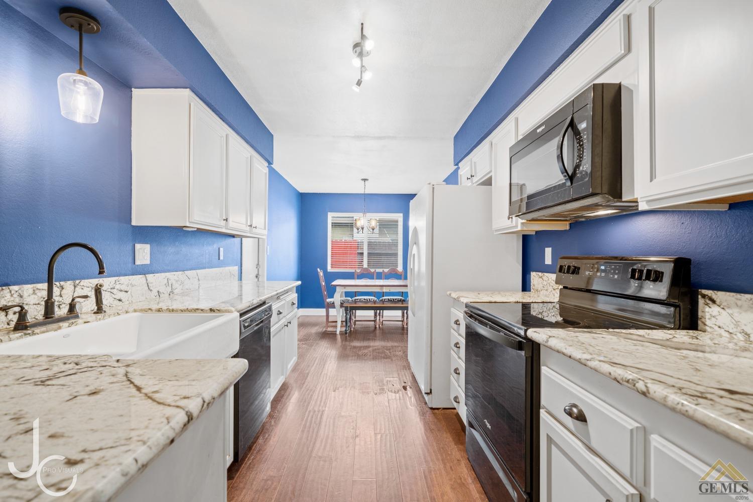 Undisclosed Address Bakersfield, CA 93308 - Photo 11 of 14 a kitchen with stainless steel appliances granite countertop a sink stove microwave and cabinets