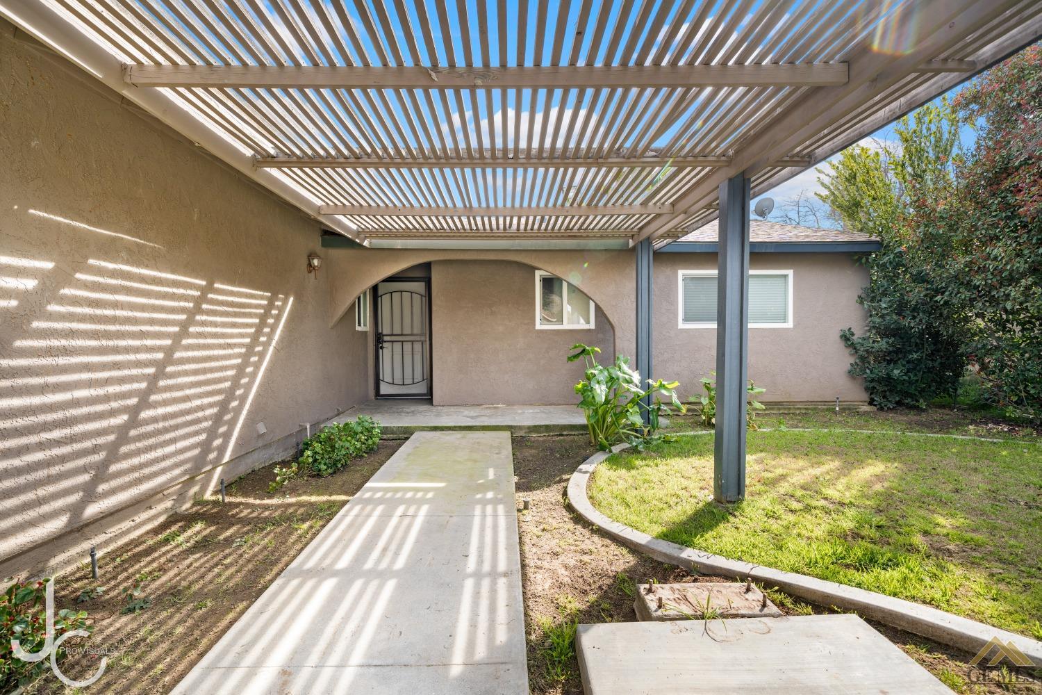 Undisclosed Address Bakersfield, CA 93308 - Photo 2 of 14 a front view of a house with garden