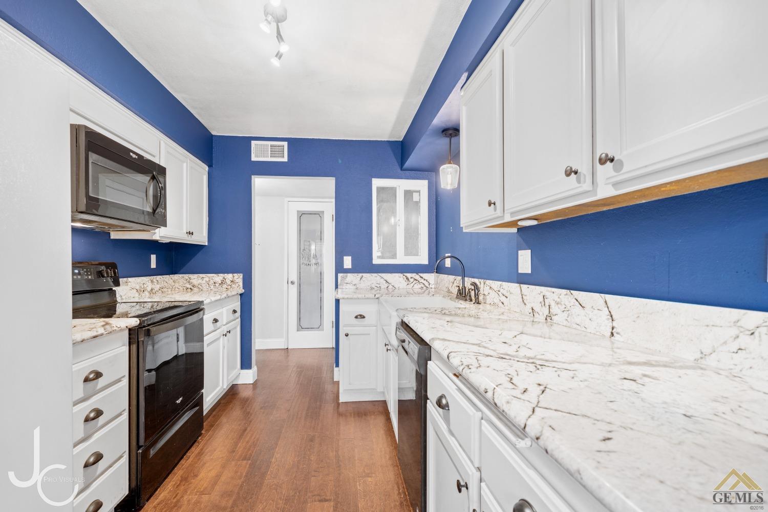 Undisclosed Address Bakersfield, CA 93308 - Photo 4 of 14 a kitchen with stainless steel appliances granite countertop a stove and a refrigerator