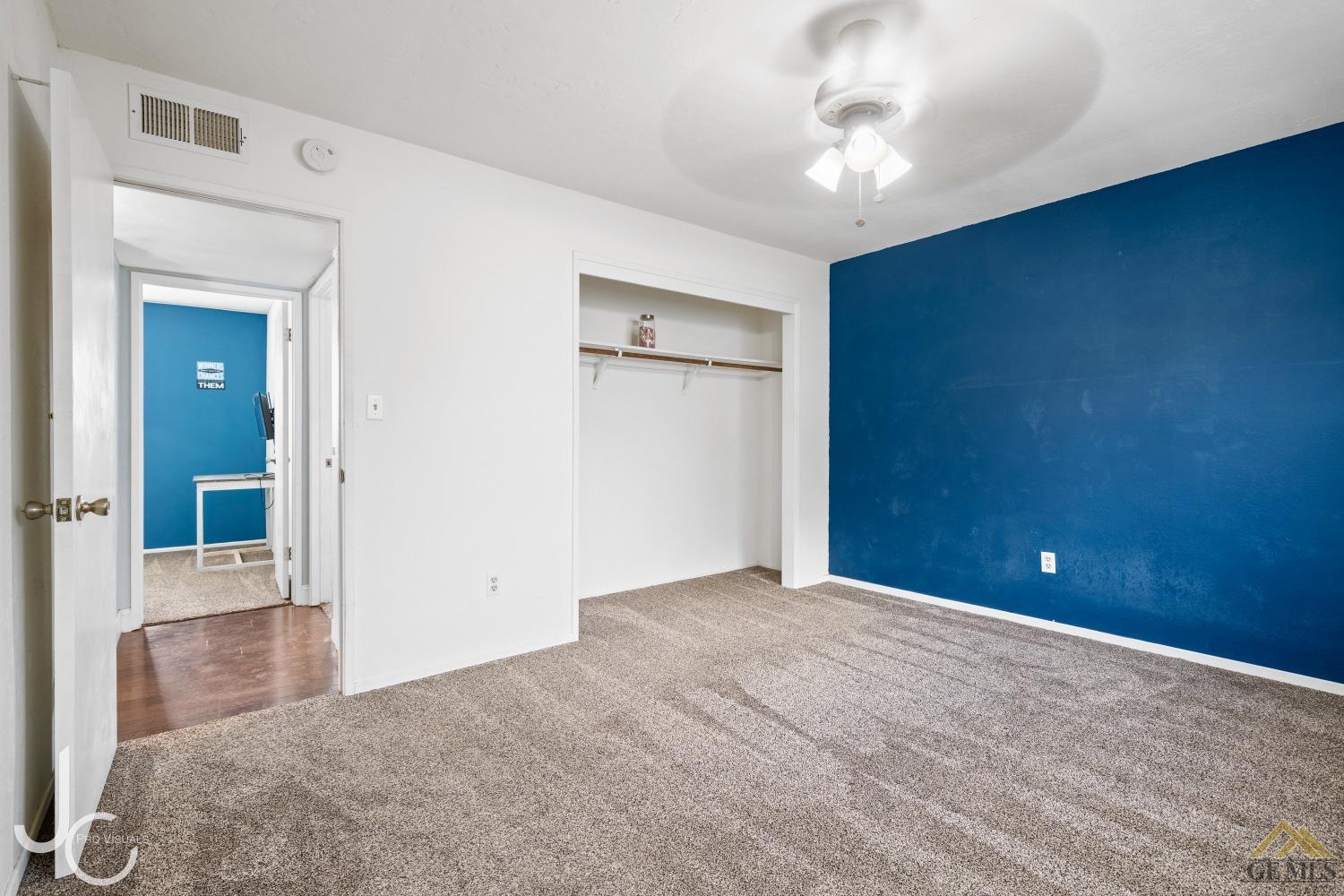 Undisclosed Address Bakersfield, CA 93308 - Photo 9 of 14 a view of a hallway with a chandelier fan