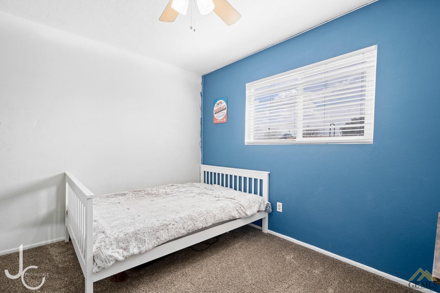 Undisclosed Address Bakersfield, CA 93308 - Photo 10 of 14 a bedroom with a bed and a window