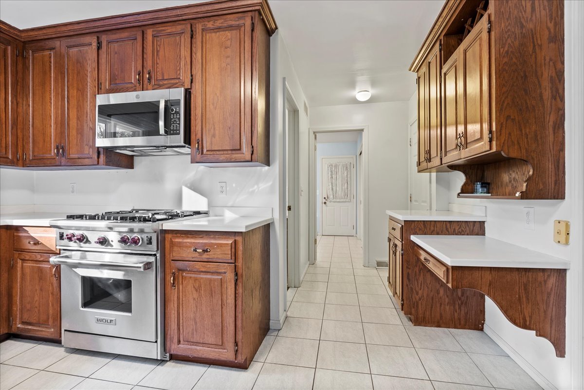 1107 Pine Ridge Court Normal, IL 61761 - Photo 11 of 50 a kitchen with a stove sink and a microwave