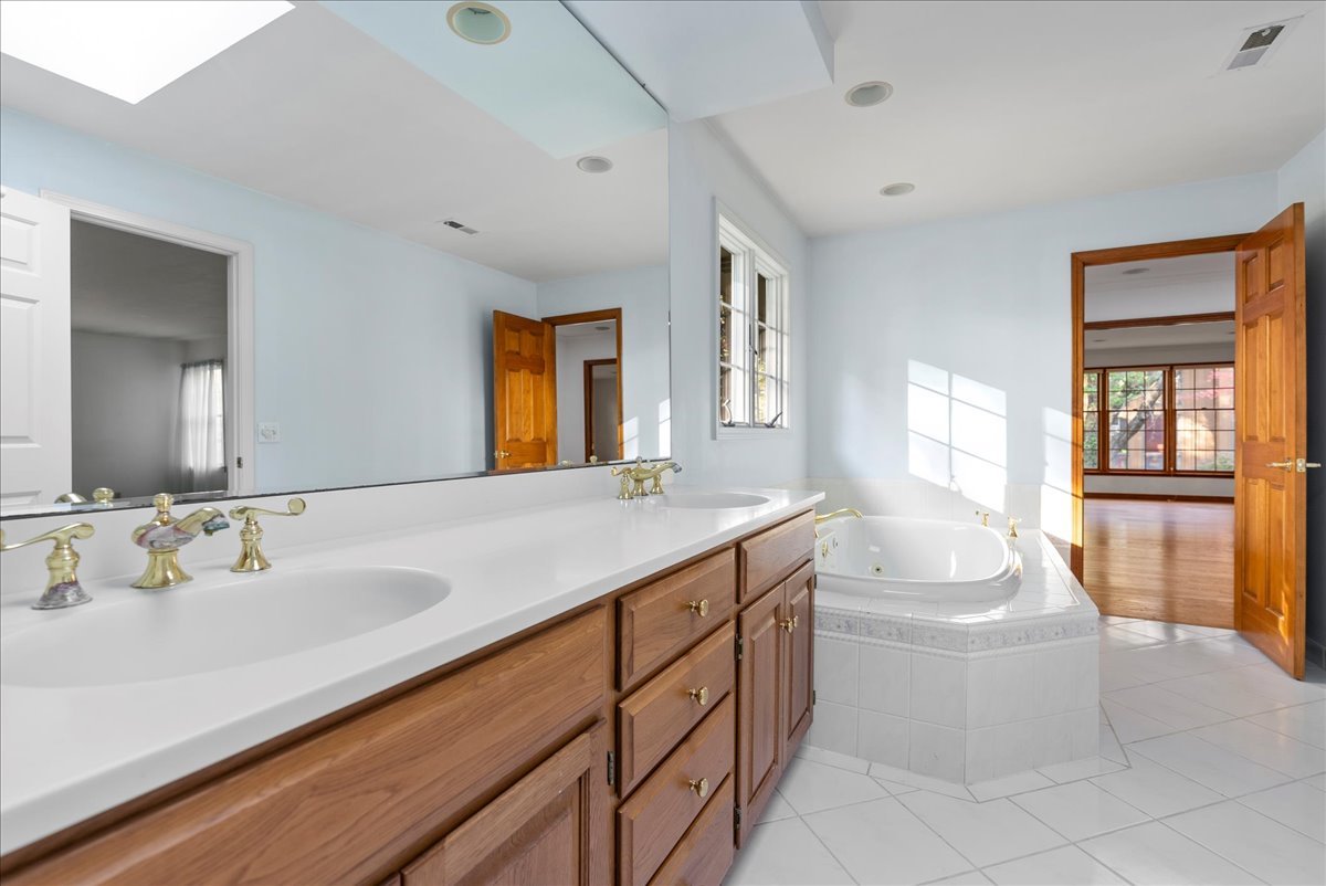 1107 Pine Ridge Court Normal, IL 61761 - Photo 27 of 50 a spacious bathroom with a double vanity sink a mirror and a