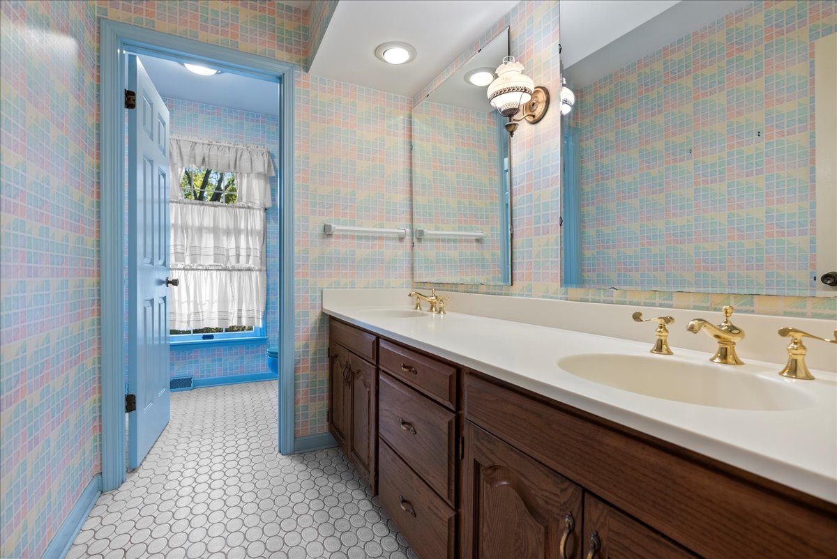 1107 Pine Ridge Court Normal, IL 61761 - Photo 33 of 50 a spacious bathroom with a double vanity sink a large mirror and shower