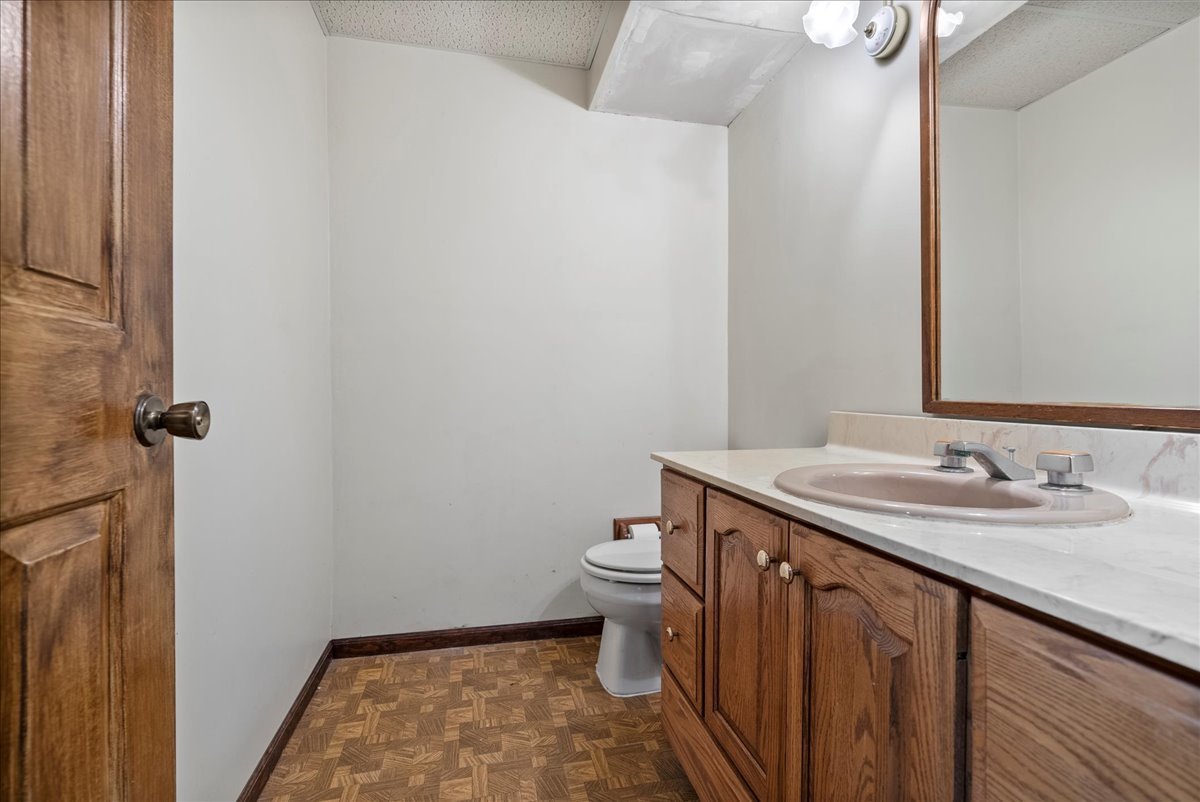1107 Pine Ridge Court Normal, IL 61761 - Photo 37 of 50 a bathroom with a granite countertop sink a toilet and a mirror