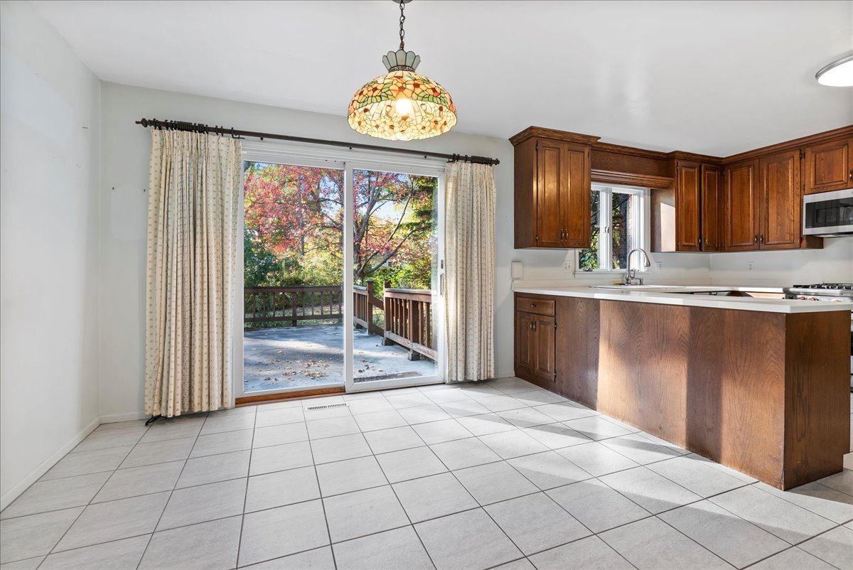 1107 Pine Ridge Court Normal, IL 61761 - Photo 7 of 50 a view of kitchen with granite countertop window and a sink