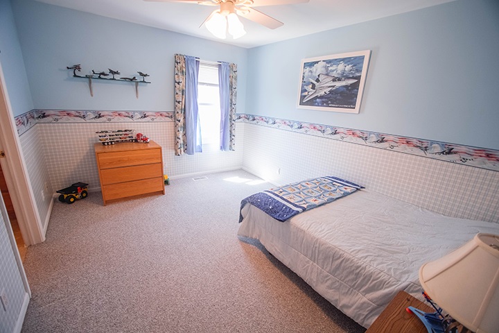 110 Pembroke Road Southwest Poplar Grove, IL 61065 - Photo 13 of 25 a bedroom with a bed and a chandelier