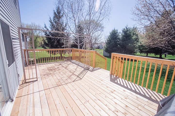 110 Pembroke Road Southwest Poplar Grove, IL 61065 - Photo 22 of 25 a view of balcony with wooden floor and fence and trees