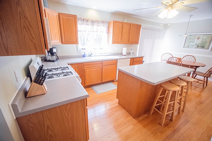 110 Pembroke Road Southwest Poplar Grove, IL 61065 - Photo 4 of 25 a kitchen with stainless steel appliances granite countertop a sink a stove a refrigerator cabinets and living room view