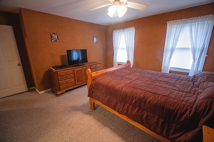 110 Pembroke Road Southwest Poplar Grove, IL 61065 - Photo 9 of 25 a spacious bedroom with a bed and a flat screen tv