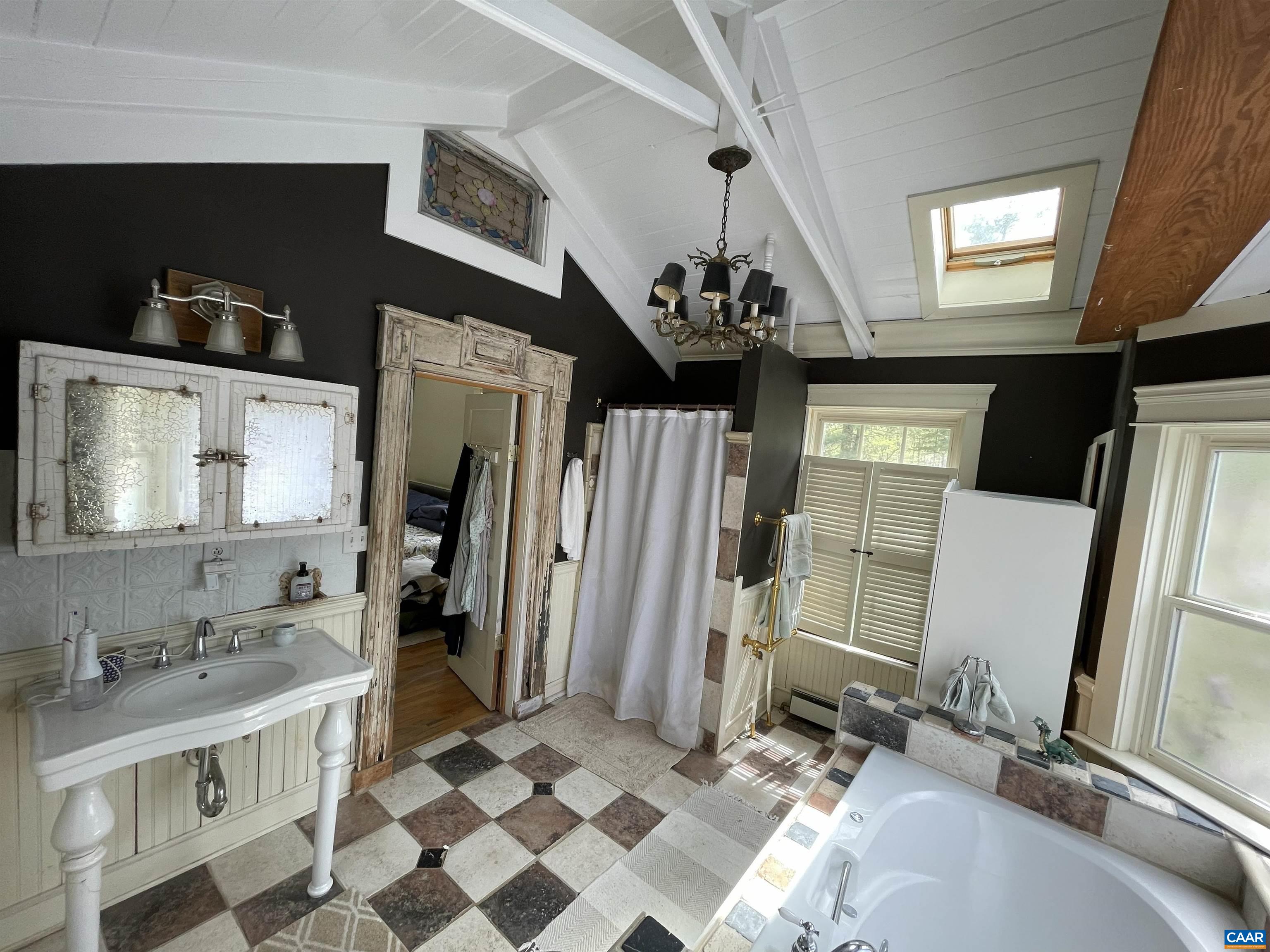 954 Old Lynchburg Road, Unit A Charlottesville, VA 22903 - Photo 12 of 44 a bathroom with a sink a mirror and a shower