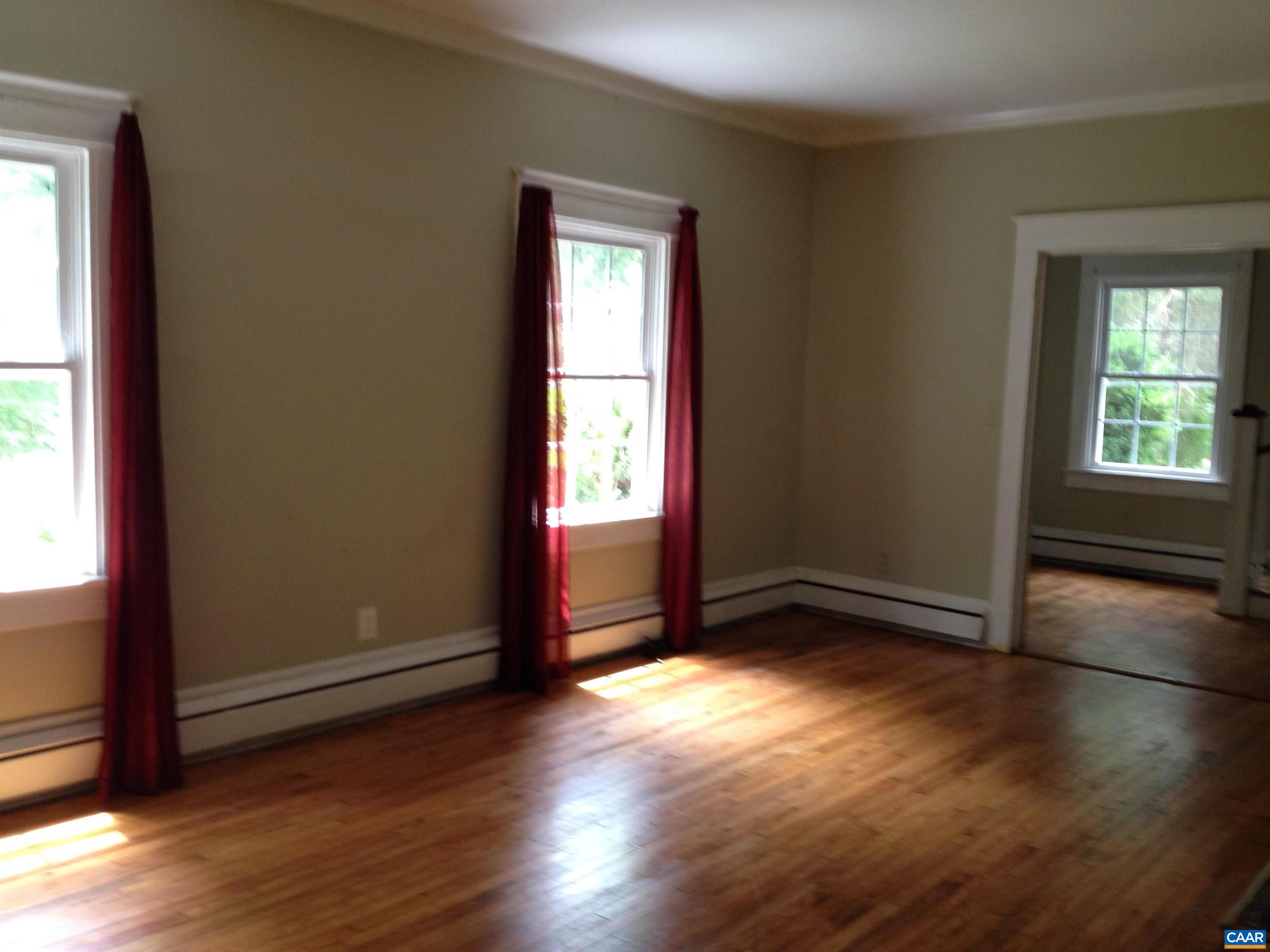 954 Old Lynchburg Road, Unit A Charlottesville, VA 22903 - Photo 18 of 44 an empty room with wooden floor and windows
