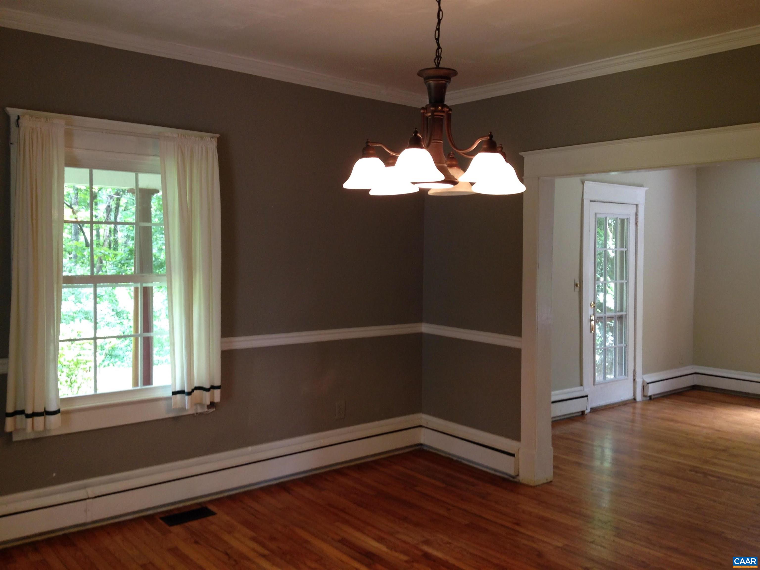 954 Old Lynchburg Road, Unit A Charlottesville, VA 22903 - Photo 19 of 44 a view of a room with wooden floor and a window
