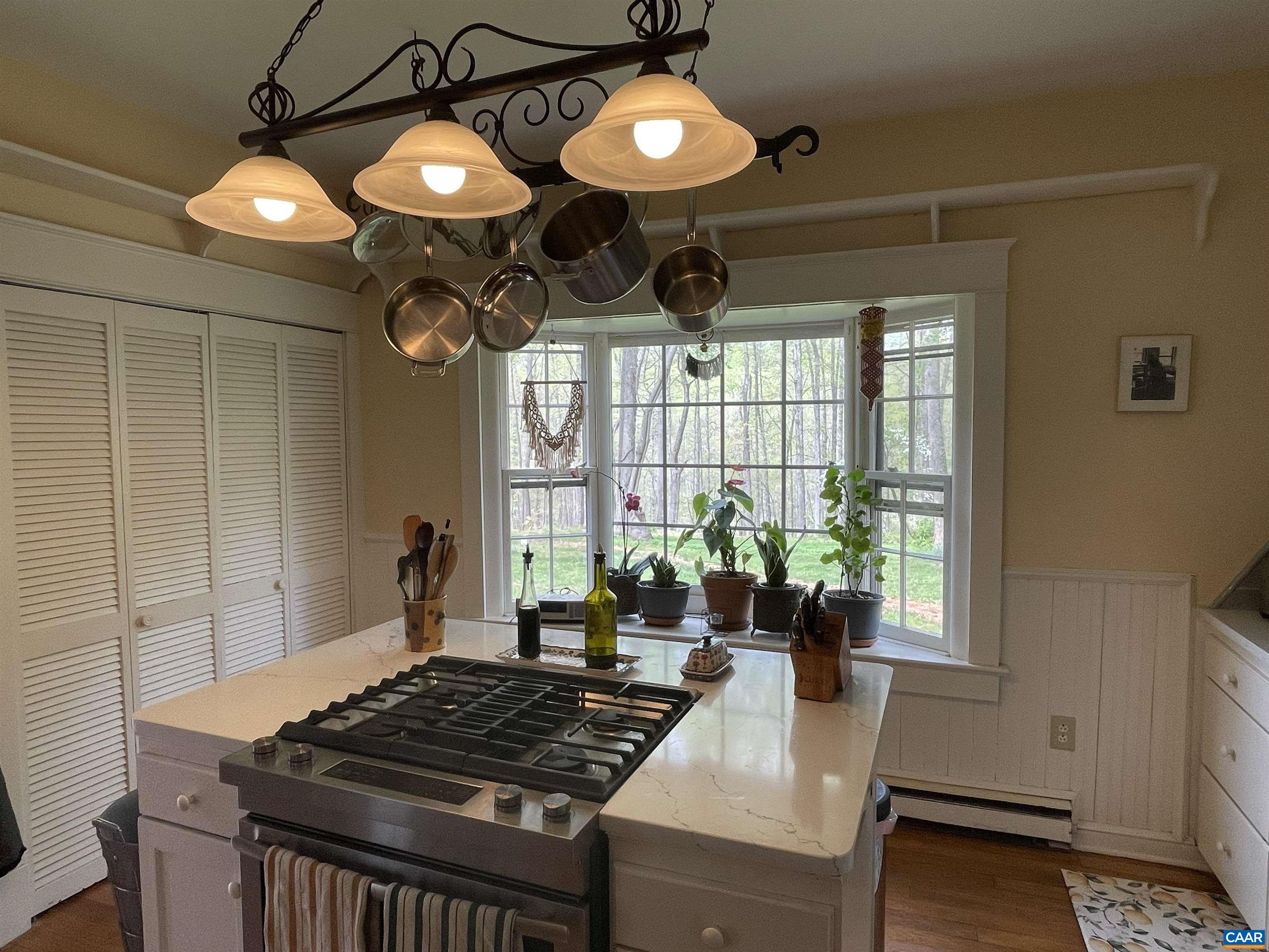 954 Old Lynchburg Road, Unit A Charlottesville, VA 22903 - Photo 6 of 44 a kitchen with a stove and a chandelier