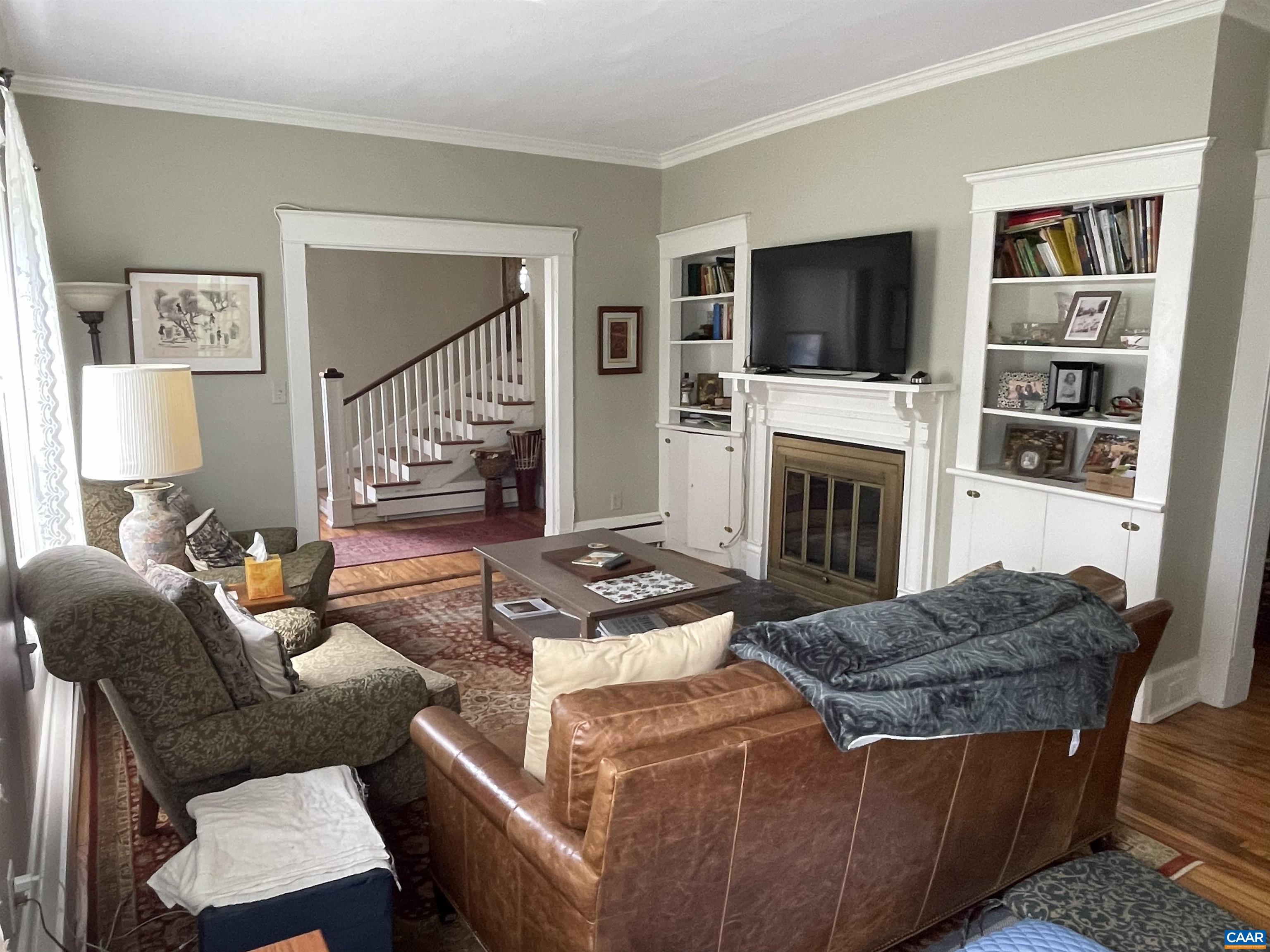 954 Old Lynchburg Road, Unit A Charlottesville, VA 22903 - Photo 7 of 44 a living room with furniture a flat screen tv and a fireplace