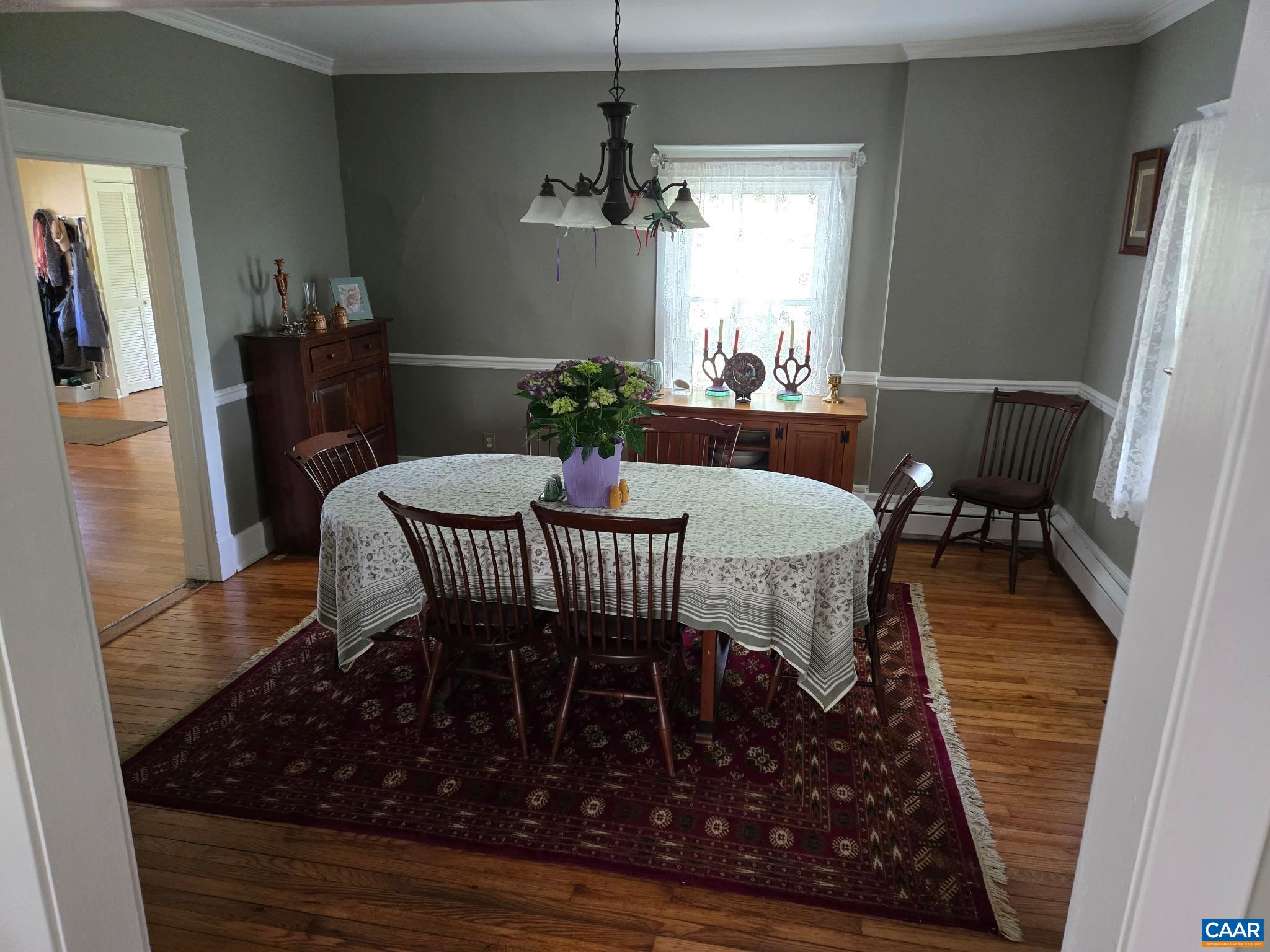 954 Old Lynchburg Road, Unit A Charlottesville, VA 22903 - Photo 8 of 44 a dining room with furniture a rug a rug and a chandelier