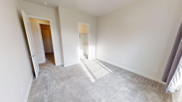 5502 North Valley View Road Lehi, UT 84048 - Photo 21 of 33 Brightly lit room featuring neutral-toned carpeting, white walls, and white trim