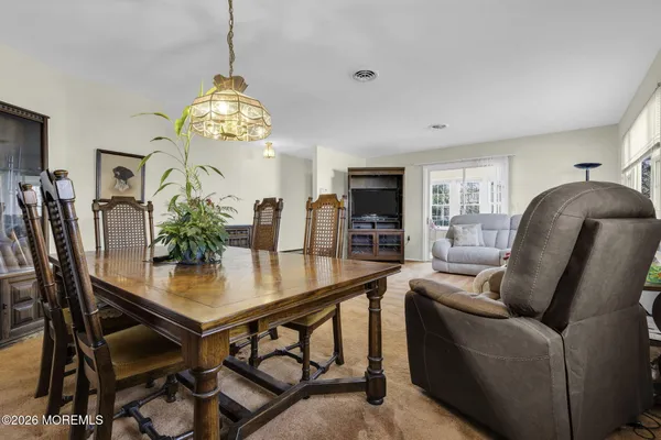 a view of a dining room with furniture and a chandelier
