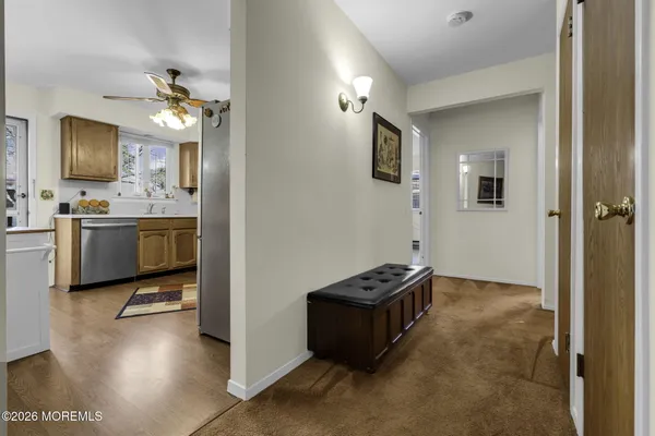 a view of kitchen with sink and refrigerator