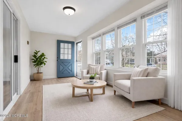 a living room with furniture and a large window