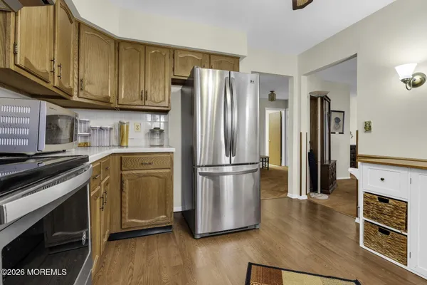 a kitchen with stainless steel appliances granite countertop a refrigerator stove and microwave