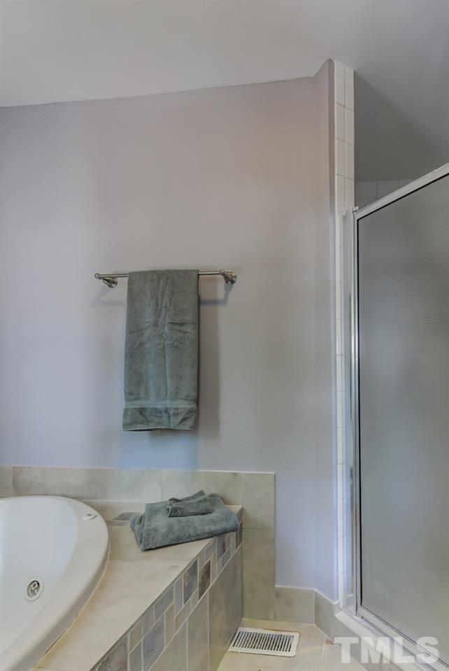 5612 Purnell Road Wake Forest, NC 27587 - Photo 11 of 23 a bathroom with a granite countertop sink and a bathtub