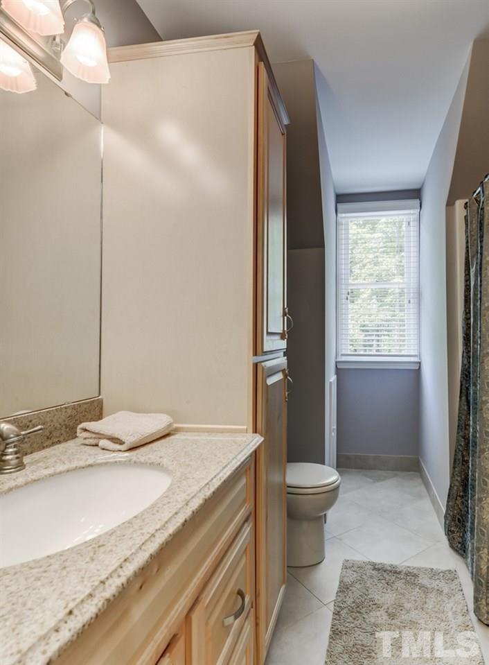 5612 Purnell Road Wake Forest, NC 27587 - Photo 13 of 23 a bathroom with a granite countertop sink toilet and shower