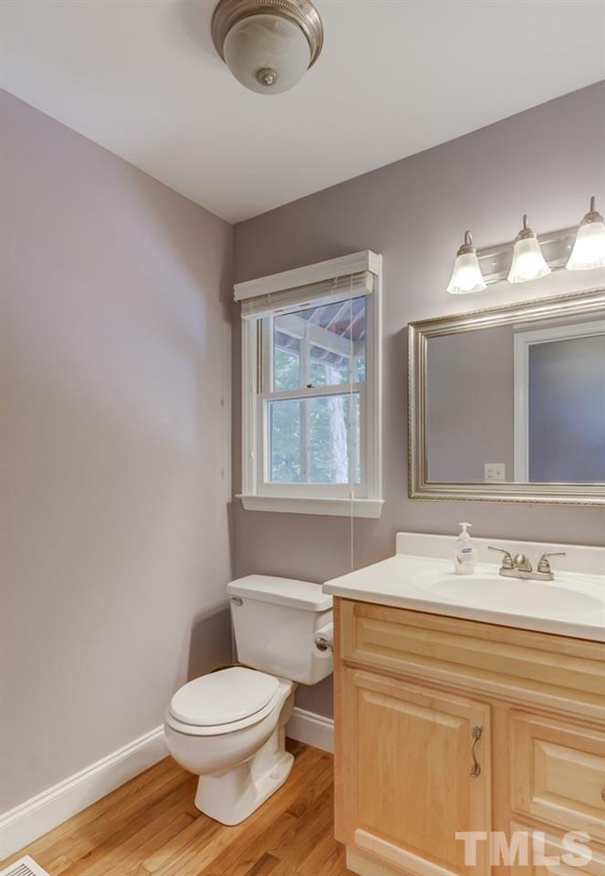 5612 Purnell Road Wake Forest, NC 27587 - Photo 17 of 23 a bathroom with a sink a toilet and mirror
