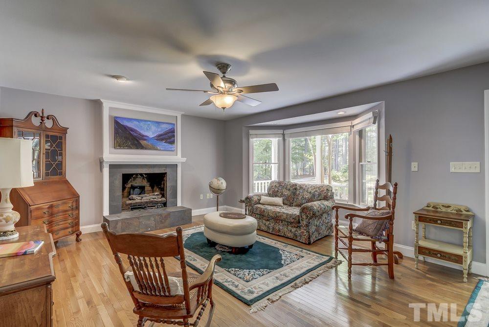 5612 Purnell Road Wake Forest, NC 27587 - Photo 3 of 23 a living room with furniture a fireplace and a large window