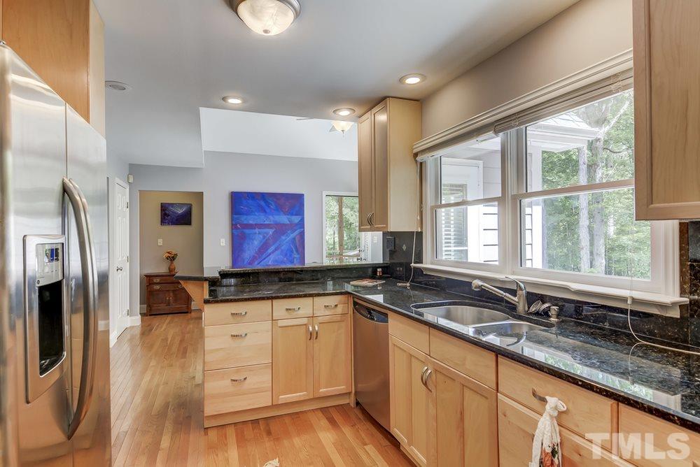 5612 Purnell Road Wake Forest, NC 27587 - Photo 7 of 23 a kitchen with granite countertop a sink stainless steel appliances and window