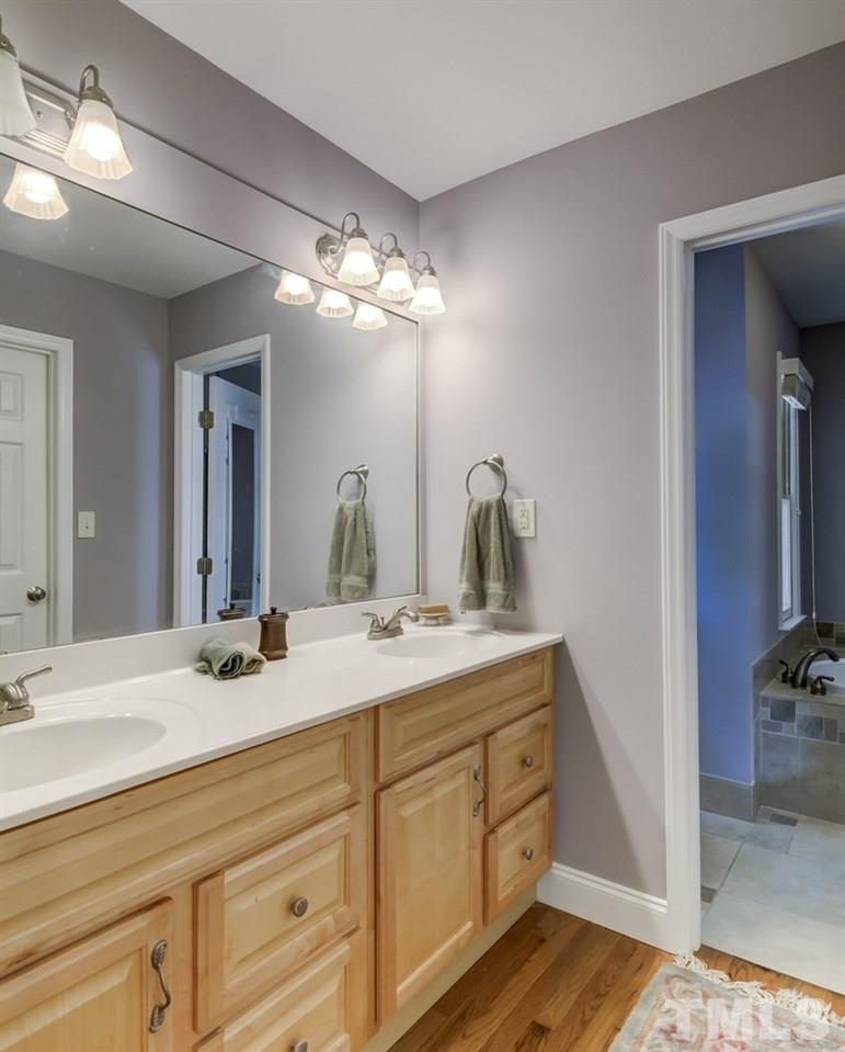 5612 Purnell Road Wake Forest, NC 27587 - Photo 9 of 23 a bathroom with a double vanity sink and a mirror