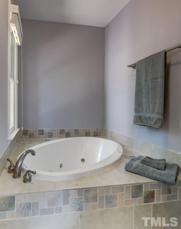 5612 Purnell Road Wake Forest, NC 27587 - Photo 10 of 23 a bathroom with a tub and a sink