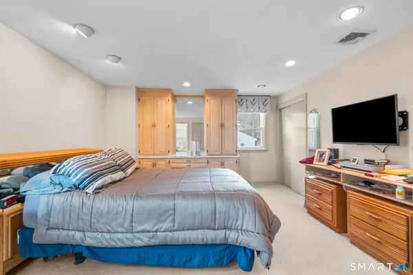a bedroom with a bed and a flat screen tv