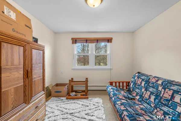 a bedroom with furniture and a window