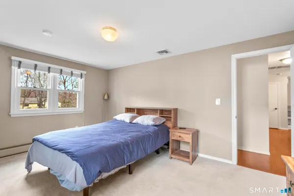 a bedroom with a bed and window