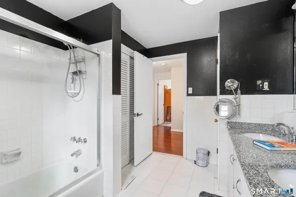 a bathroom with a tub sink and shower