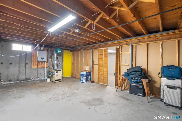 a view of a storage room with furniture and large windows