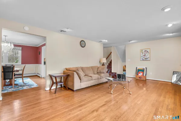 a living room with furniture and wooden floor