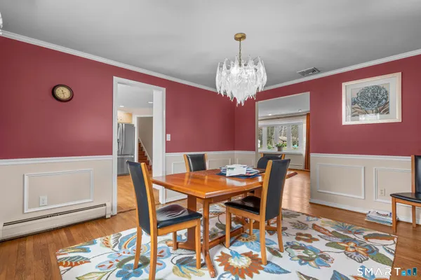 a view of a dining room with furniture and wooden floor