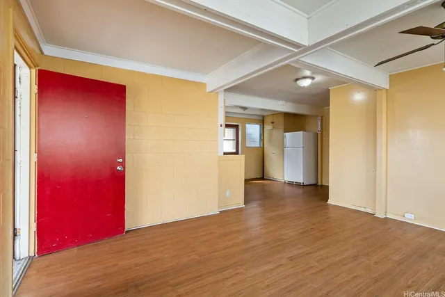 a view of empty room with wooden floor