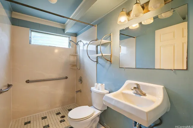a bathroom with a sink mirror and toilet